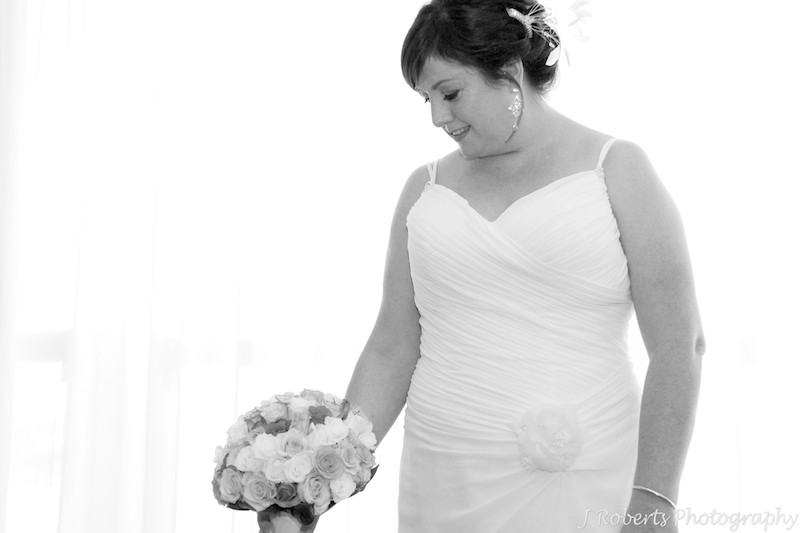 Bride looking at her bouquet - wedding photography sydney